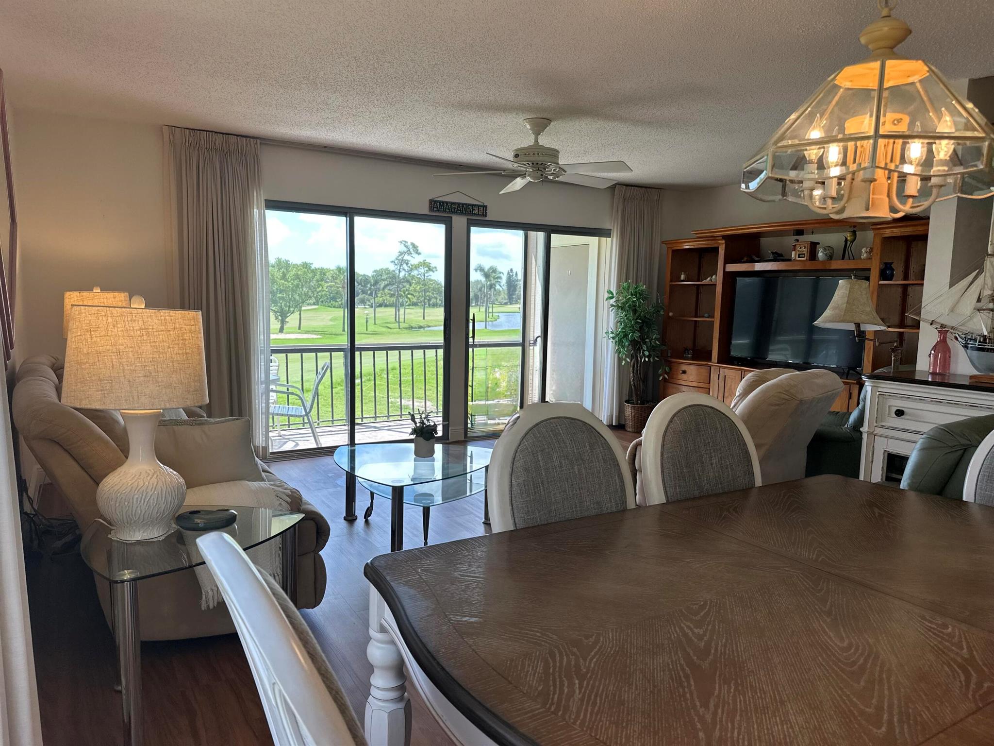 Welcome to luxury living at Riverbend Country Club! This exquisite 2-bedroom, 2.5-bathroom condo offers a perfect blend of comfort and elegance with stunning sunrise views of hole #15 and a large picturesque lake. Immerse yourself in the serene beauty of Riverbend's private golf course, designed by Tom Fazio, often hailed as the ''Jewel of the Loxahatchee.'' As you step into this meticulously maintained residence, you'll be greeted by breathtaking views. The spacious balconies, beckon you to unwind and soak in the natural beauty that surrounds. The living and dining areas feature brand new