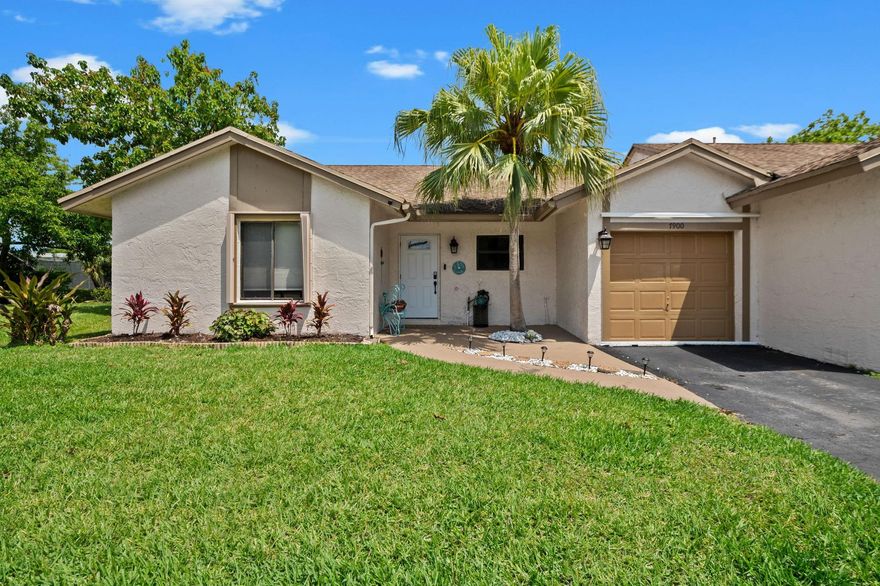 This home features 3 bed/2 bath & a 1-cg. Home attached on one side.  Beautiful updated kitchen & baths. The  kitchen boast wood cabinets, stainless steel appls., granite counters, & an eat-at island. The spacious liv. & din. area has glass doors leading to a screened patio. The primary bdrm includes a walk-in closet & remodeled bthrm The 3rd bedroom, currently used as a den/family room, is easily converted back to a bedroom by adding a wall & door. The garage is being utilized as an additional room & is air-conditioned, remains a garage w/ a garage door. Additionally, it is equipped w/ accordion hurricane shutters & offers the benefit of no neighbors behind, ensuring a quiet & peaceful atmosphere. The community offers a clubhouse & pool. Don't miss out on this move in ready home.