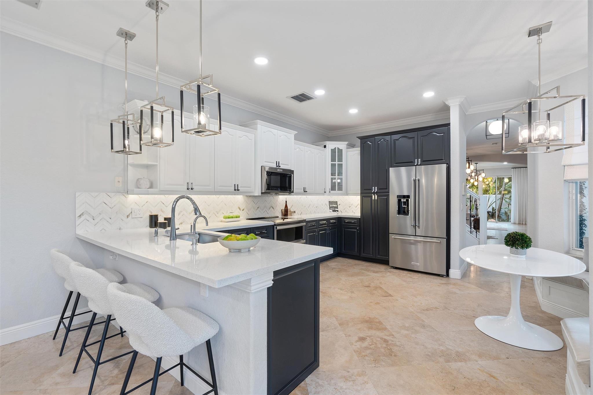 Located in the heart of Victoria Park in Fort Lauderdale, this stunning 4 bedroom /3.5 bath Fee simple townhome upgraded to offer luxury and modern conveniences. New renovated kitchen features new appliances and hardware, custom-built bar with two 100-bottle wine coolers and a lighted display—perfect for entertaining. Two Primary suites, one on the first floor. Relax in the spa-like primary bath with a whirlpool tub, towel dryer, and Toto Washlet toilets. Outdoor oasis includes a recently resurfaced saltwater pool with a brand-new chlorination system, updated equipment, and an Alfresco natural gas grill, revamped landscaping and a mosquito repellent system. Whole-home generator, security system and cameras. NO HOA or NO RESTRICTIONS. ALL PETS WELCOME. VACATION RENTAL ALLOWED.