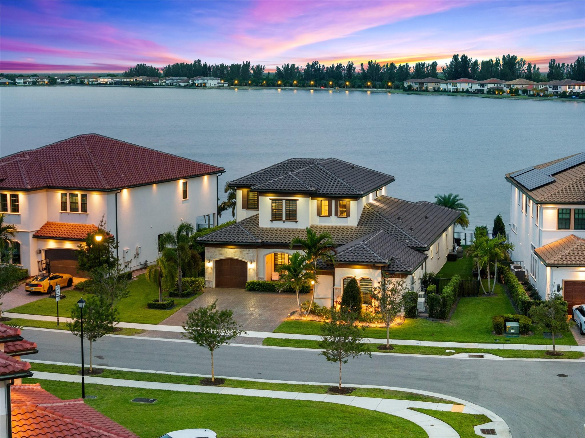 LOWEST Priced Pool Home On The Big Lake! Over $200K In Upgrades! 4 Full Beds + Office + Loft, 3.5 Baths Waterfront Pool Home, 3-Car Garage. Updated Heated Swimming Pool w/Sun Shelf, Water & Fire Features, Extended Fenced-In Pavered Patio, Retractable Screens, Built-In Summer Kitchen w/Speakers, Almost 11,000 SqFt Lot w/Extra Space On Both Sides Of Lot w/Artifical Turf, Primary Bed w/Sitting Area On 1st Floor, Walk-In Closet w/Built-In's, Spa-Like Bath w/Separate Vanities, Huge Shower & Soaking Tub, Bonus Room/Office Downstairs, Upstairs Loft & On-Suite Bed & Bath & 2 More Separate Beds, Smart Home System, Impact Windows & Doors, On Gas, Enjoy Amazing Sunsets & Gorgeous Water Views, Chef's Kitchen, Resort-Style Amenities, Clubhouse, Fitness Center, A+ Rated Schools, & 24-Hour Guard Gate.