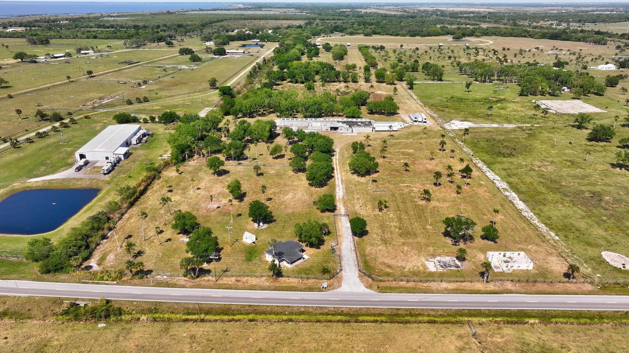 Amazing Opportunity - Wide Open Space on 55 Acres, Home Features 2 Bedroom 1 Bath with Tile Flooring, Kitchen with Lots of Cabinets, Impact Windows, Water Filtration System, Spacious Covered Porch, Property Encompasses 55 Acres Cleared and Fully Fenced, Storage Buildings, 6 inch Well, 3 Phase Electric, Minutes to Lake Okeechobee, 20 Minutes to Stuart, Must See