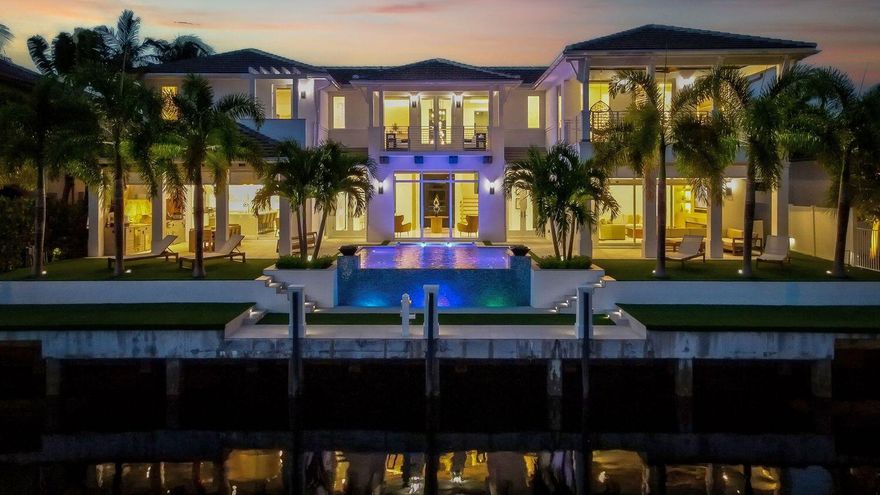 Experience coastal luxury at this 2023-built waterfront masterpiece offering 85 feet on the water with a brand-new dock and seawall on a wide canal. Spanning 3,866 SF with 4 bedrooms and 4 bathrooms, this smart-home residence combines cutting-edge technology, timeless elegance, and seamless indoor-outdoor living. Enter through the private gated entry into a space featuring motorized chandeliers, Control4 automation, large format 4x4 porcelain tile, and white French oak flooring throughout. The gourmet kitchen boasts quartz countertops, high-end Dacor appliances, a 500-bottle wine room, and an espresso bar. Three bedrooms enjoy private balconies, while the primary suite elevates comfort with spa-inspired finishes. The professional summer kitchen includes dual grills, refrigerators,