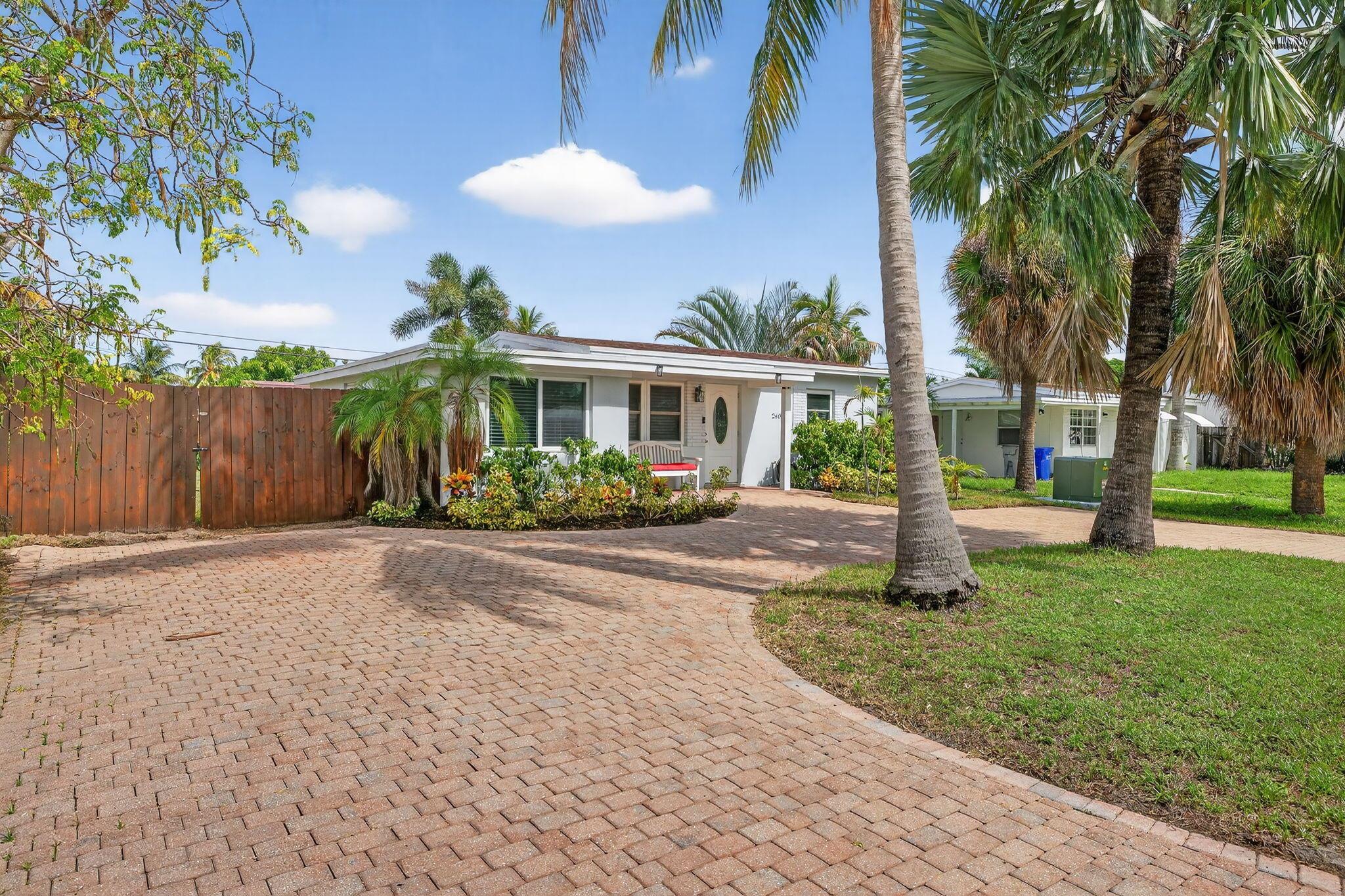 Turnkey Coastal Living in Pompano Beach -Welcome to 2600 NE 14th Terrace -- a beautifully updated home just minutes from the beach. This 3-bedroom, 1-bath residence has been thoughtfully renovated inside and out, with a long list of big ticket upgrades: impact windows & doors, new roof, new A/C with smart thermostat, all new appliances, tankless water heater, and new electrical panel. The bathroom was fully renovated with updated plumbing and electrical and the flexible 3rd bedroom is perfect for a home office or guest space. Every major system has already been taken care of so you can move right in with peace of mind.Step outside to a private backyard with a new privacy fence, a double gate for boat/RV storage, and plenty of room for a pool. (continued....)