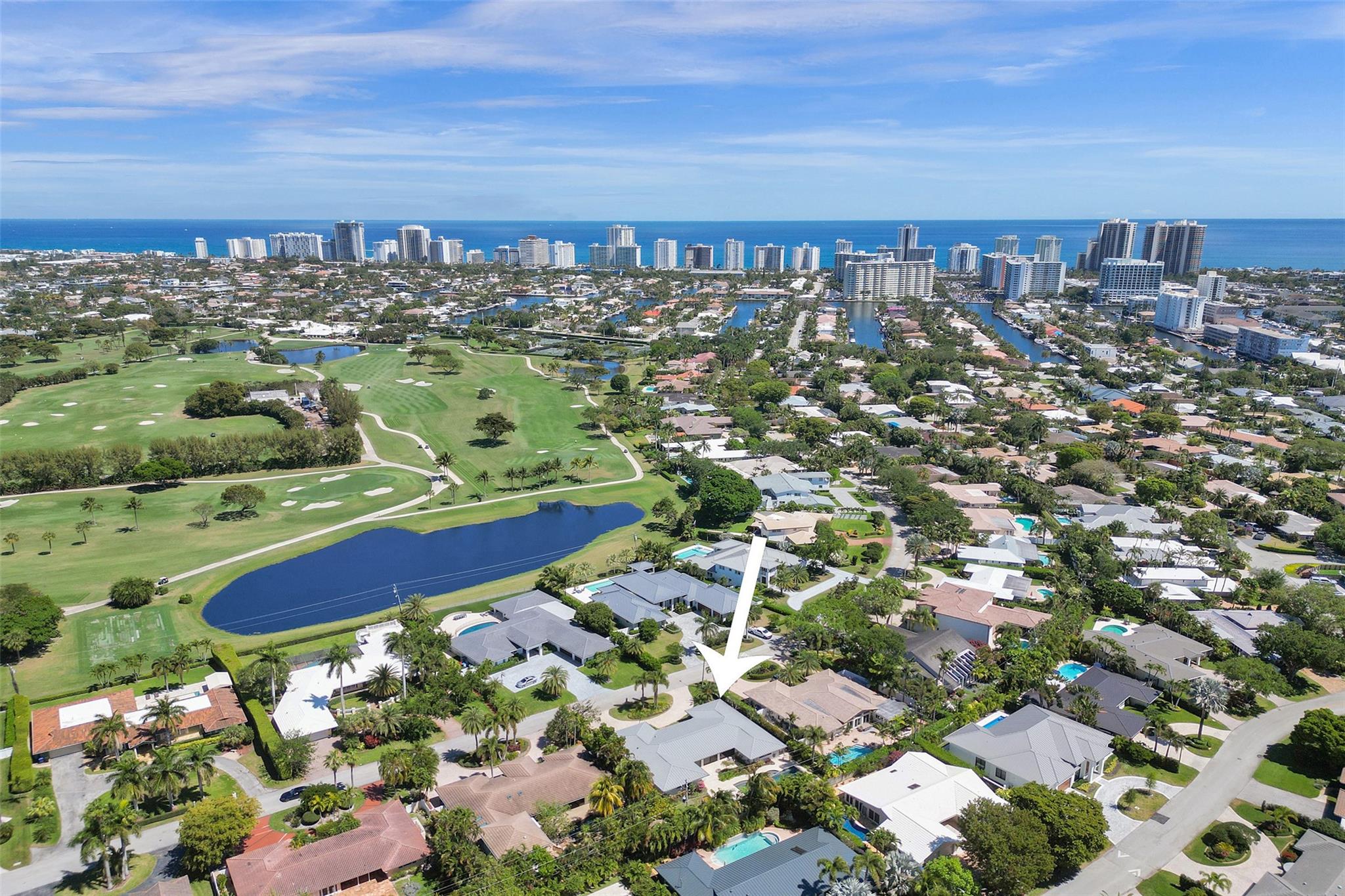 Welcome to your exquisite retreat in the prestigious Coral Ridge Country Club neighborhood of Fort Lauderdale. This beautifully remodeled home offers 3,295 square feet of luxurious living space, featuring four spacious bedrooms, a dedicated home office, and three and a half elegantly remodeled bathrooms. Step inside to discover an open floor plan with porcelain tile floors in the central area and hardwood in the bedrooms. The expansive living area flows seamlessly to the pool and patio through three sliding doors. Surrounding the large 15x40 pool, the lush backyard is adorned with mature trees, creating an ideal setting for entertaining and relaxation. This home has many upgrades including brand-new impact windows, a new pool heater, a 2020 metal roof, 2024 AC, and a tankless water heater.