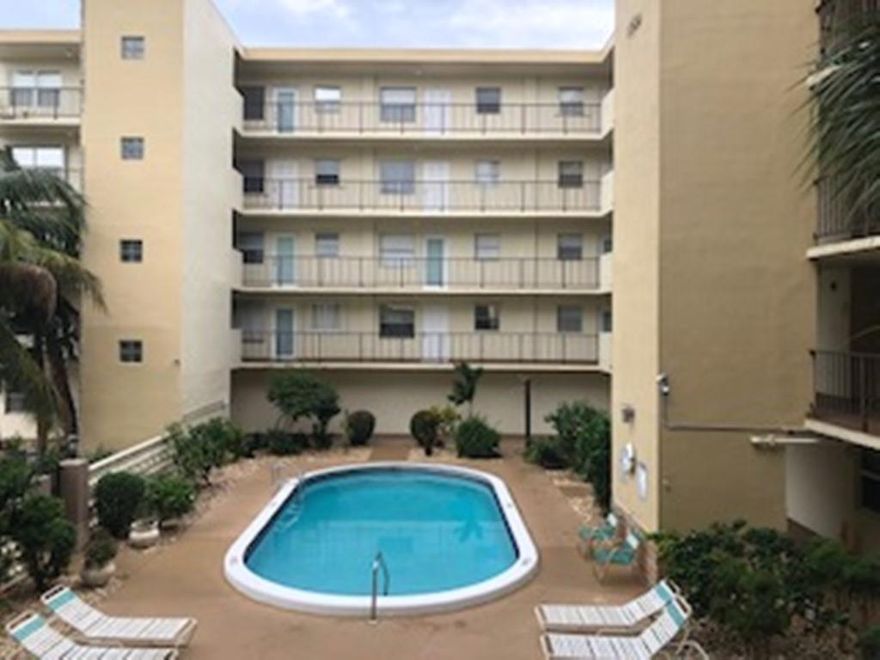 Great price, great location near downtown Hollywood & the beaches. 55+ building. Investor/Handyman special for this spacious 1 bedroom, 1 & 1/2  bath east facing second floor unit overlooking the pool/courtyard, open balcony off bedroom, Impact front door. Original condition waiting for your personal style. Quaint well maintained boutique building of 50 units, common laundry room w/unit storage on each floor, gated, assigned parking space by front gate entry. Unit located close to the elevator & stairway. No leasing, No pets permitted. Furniture included. Low maintenance fee of $ 206.50 monthly includes water, trash removal & more. Future special assessment 40 year inspection. Hurry, won't last!!