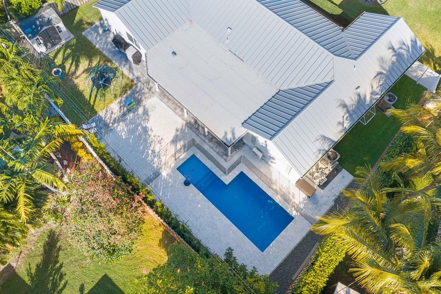 Welcome to one of Lighthouse Point's most versatile pool homes. This 4-bed, 3-bath CBS residence features a rare triple-split floor plan — ideal for multi-generational living, a home office, or guest suite — all on one level. The heated saltwater pool and fenced backyard create a private outdoor retreat, while a 2-car garage with epoxy floors adds everyday convenience. Major updates are already done: brand-new 2023 metal roof, complete impact glass throughout, and 2022 AC. No HOA, no restrictions. Minutes to marinas, dining, and the beach. A true South Florida lifestyle home priced to move. This thoughtfully laid-out home gives buyers something increasingly rare in Lighthouse Point: space, flexibility, and major capital improvements already completed. The triple-split floor plan separates the primary suite from secondary bedrooms, offering true privacy for owners while accommodating guests, a home office, or a gym without sacrificing bedroom count. The heated saltwater pool anchors a fully fenced backyard with an open patio and covered patio portion — perfect for year-round entertaining. Inside, the kitchen and family room flow seamlessly for everyday living. The oversized 2-car garage features epoxy floors, laundry, and pull-down attic storage. Additional highlights include a built in wine cooler and bar, walk-in closets, plantation shutters, and custom lighting throughout. For the practical buyer: the 2023 metal roof, complete impact glass, and CBS construction provide exceptional insurance value and true peace of mind. Located on a quiet street in the heart of Lighthouse Point — no HOA, close to Dan Witt Park, top-rated schools, waterfront dining, and Lighthouse Point Marina.