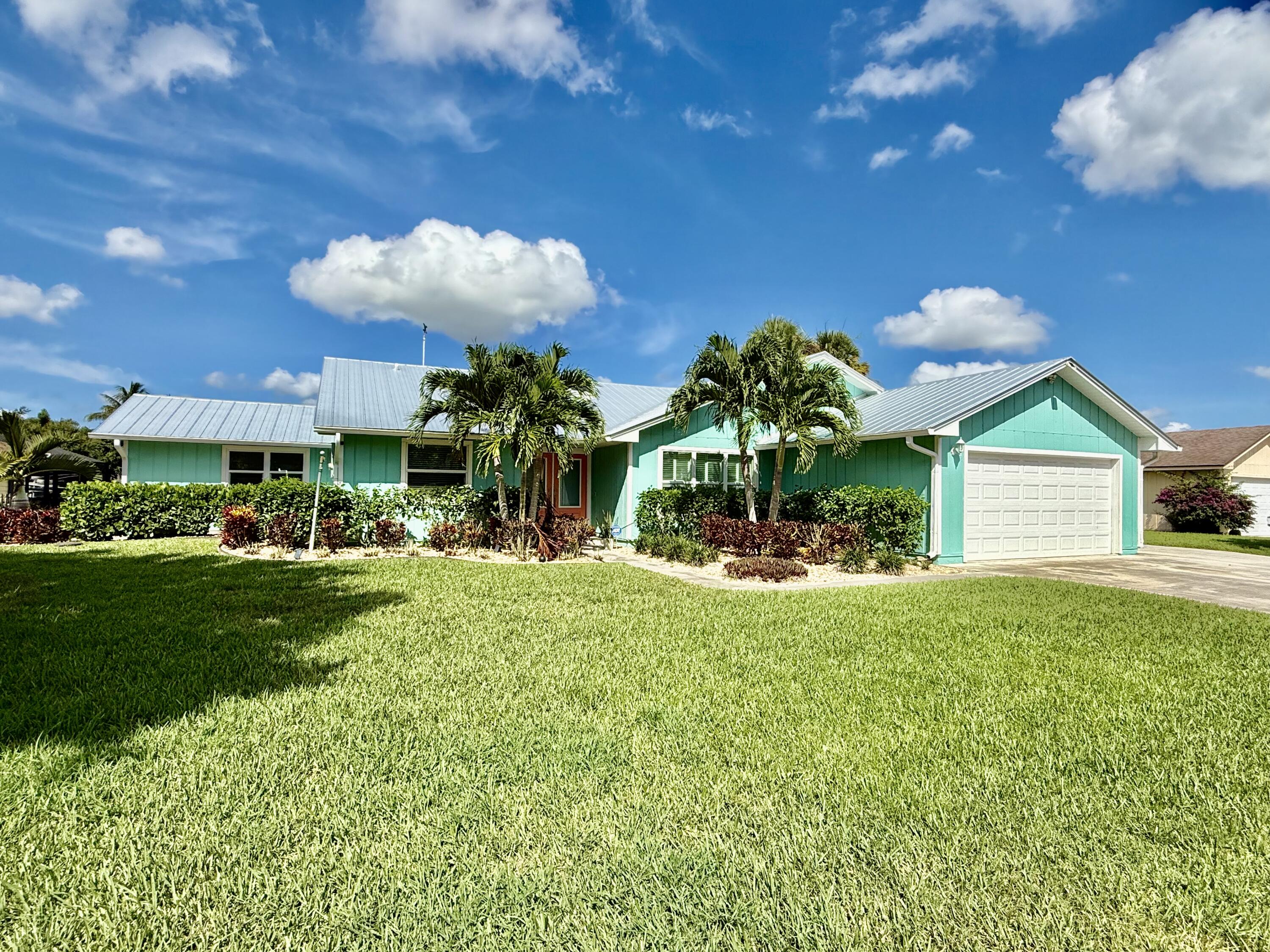 Rare Opportunity! Boaters Dream home! New seawall, doc and boat lift in your back yard! 3 bed 3 bath plus a Den! One bedroom is included as an in-law suite, additional den and kitchenette. Not to mention the Florida room and open floor concept. This home is almost completely remodeled, energy efficient with a New roof and AC! Very popular Palm city area, quiet community with the park and dog park near by! The boat lift holds up to 10,000lb with a boat ramp just feet away. All this is just waiting for someone who will take great care of it. 20 Minutes to the river and 30 min to the ocean. Is this what you've been waiting for? Don't miss this Rare opportunity!