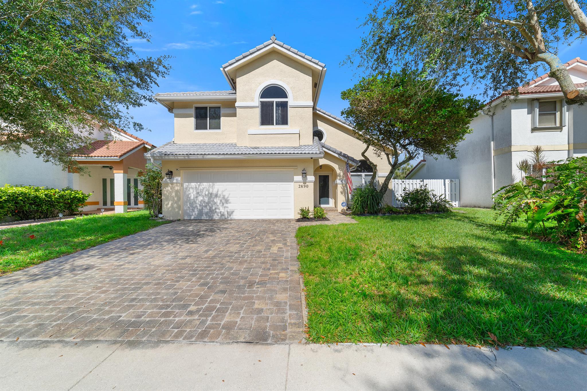 Tucked away in Coral Lake Estates, this charming 3-bedroom, 2.5 bath home offers 2,036 sq. ft. of inviting living space, highlighted by tranquil canal views and a backyard that feels like your own private nature retreat. Soaring ceilings, impact windows and doors, and abundant natural light from generous windows create a bright and airy atmosphere throughout. Downstairs, tile flooring provides durability and style, while warm wood flooring upstairs adds a cozy touch. The thoughtfully designed kitchen opens to a spacious covered patio complete with a summer kitchen, ideal for relaxing or entertaining guests. One of the home's standout features is the primary suite's closets, yes, plural, including one that's the size of a bedroom.