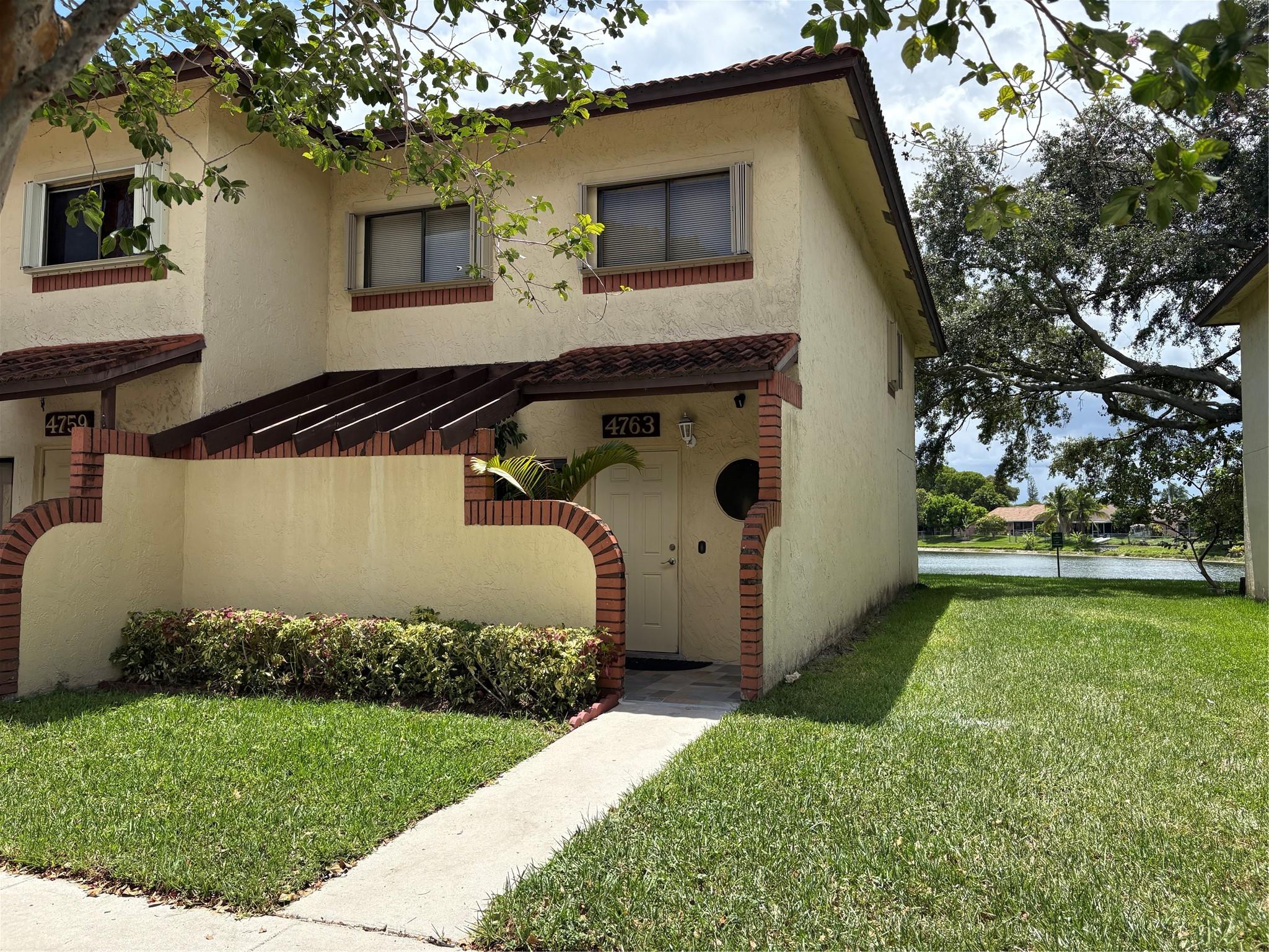 Enjoy serene lake views from this spacious 3-bed, 2.5-bath end unit in a prime Sunrise location. The spacious eat-in kitchen features rich wood cabinetry and stainless steel appliances. Wood-look tile floors, crown molding, and under-stair storage add style and function. Huge patio with newer tiles, newer washer and dryer and a prime, convenient location, this two-story townhome offers comfort, charm, and unbeatable value.
