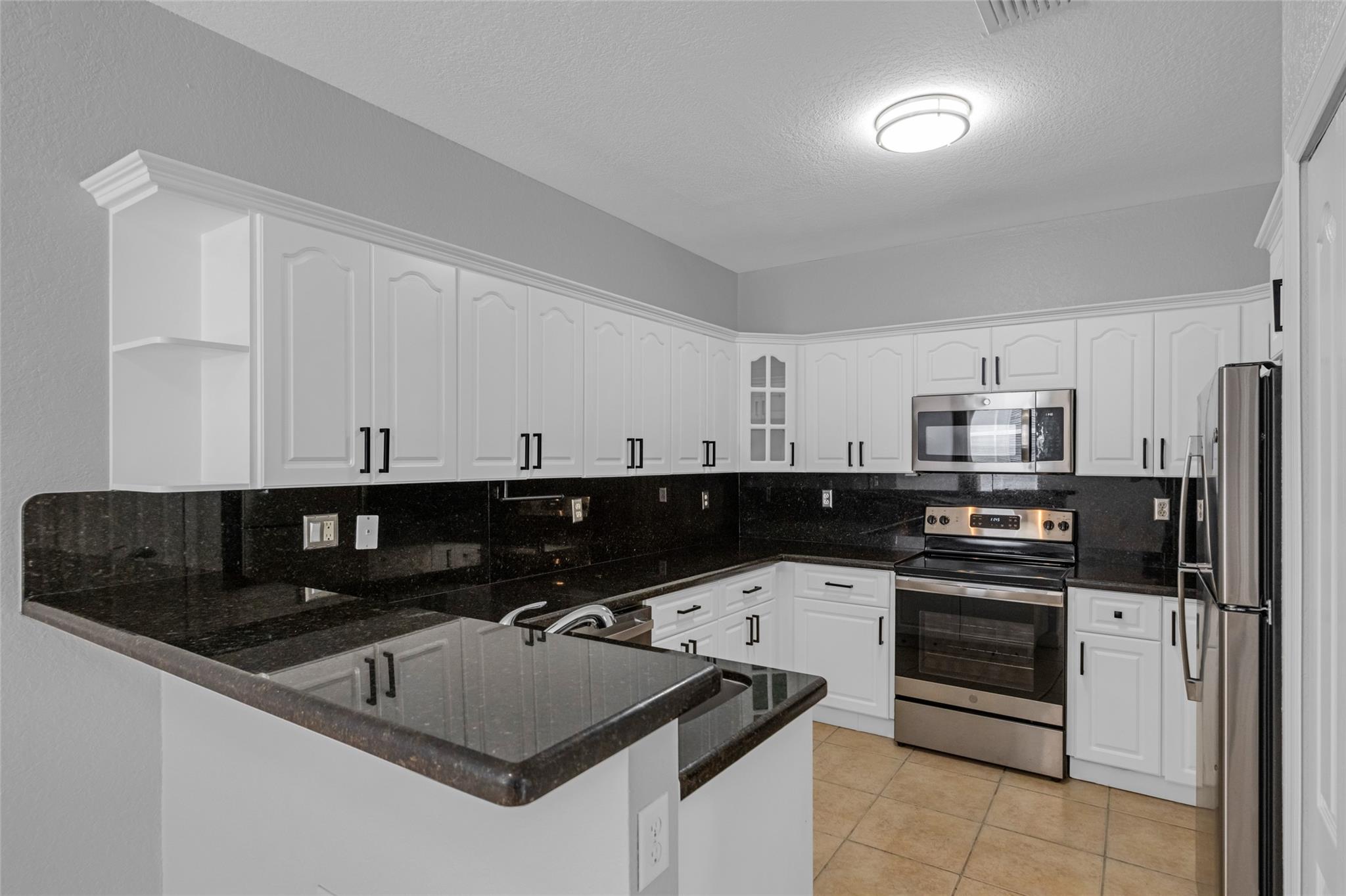 Beautifully remodeled 2-story townhouse condo in a gated community in West Miramar! This home features a modern kitchen with granite countertops, white cabinetry, and stainless steel appliances. The bathrooms are elegantly updated with porcelain tile flooring and a walk-in shower. Vinyl flooring enhances the stairs and bedrooms, and the entire unit has been freshly painted. Enjoy a private balcony with peaceful lake views. Comes with 2 assigned parking spaces. Community amenities include a pool, playground, and gym. Top rated schools. Conveniently located near I-75, shopping, dining & more. Easy to show!