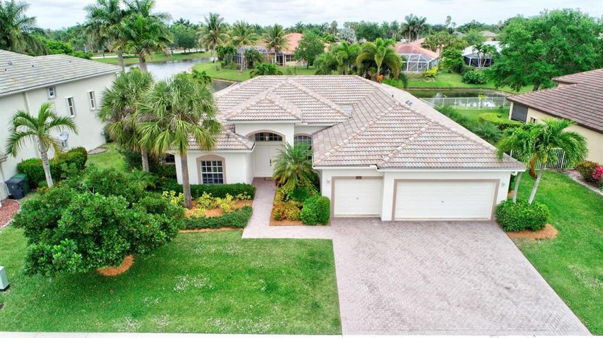 Welcome Home! This truly remarkable home and rare opportunity awaits even the most discerning of buyers. Priced to sell, this home may reflect as 4 bdrms on the tax records, but is a true 5/3 offering the immediate feeling of home with its very spacious layout & High ceilings.  Situated on just over a quarter acre your eyes will be dawn to full pool & lake views upon entering the double front door entry. 2954sqft under air & 3798sqft total.  Your new home offers a large 3car garage, Screened Lanai over the Custom Paver Pool Deck, Whirpool Pool Feature, Cabana Bath, Natural light Throughout, Tranquil Water Views, Ample Closet Space, Dual A/C, and Much Much More...Walk to the clubhouse, 24hr Guard Gte, Patrolled by PBSO, A community to call home - This is a 1 of a kind property & opportunity