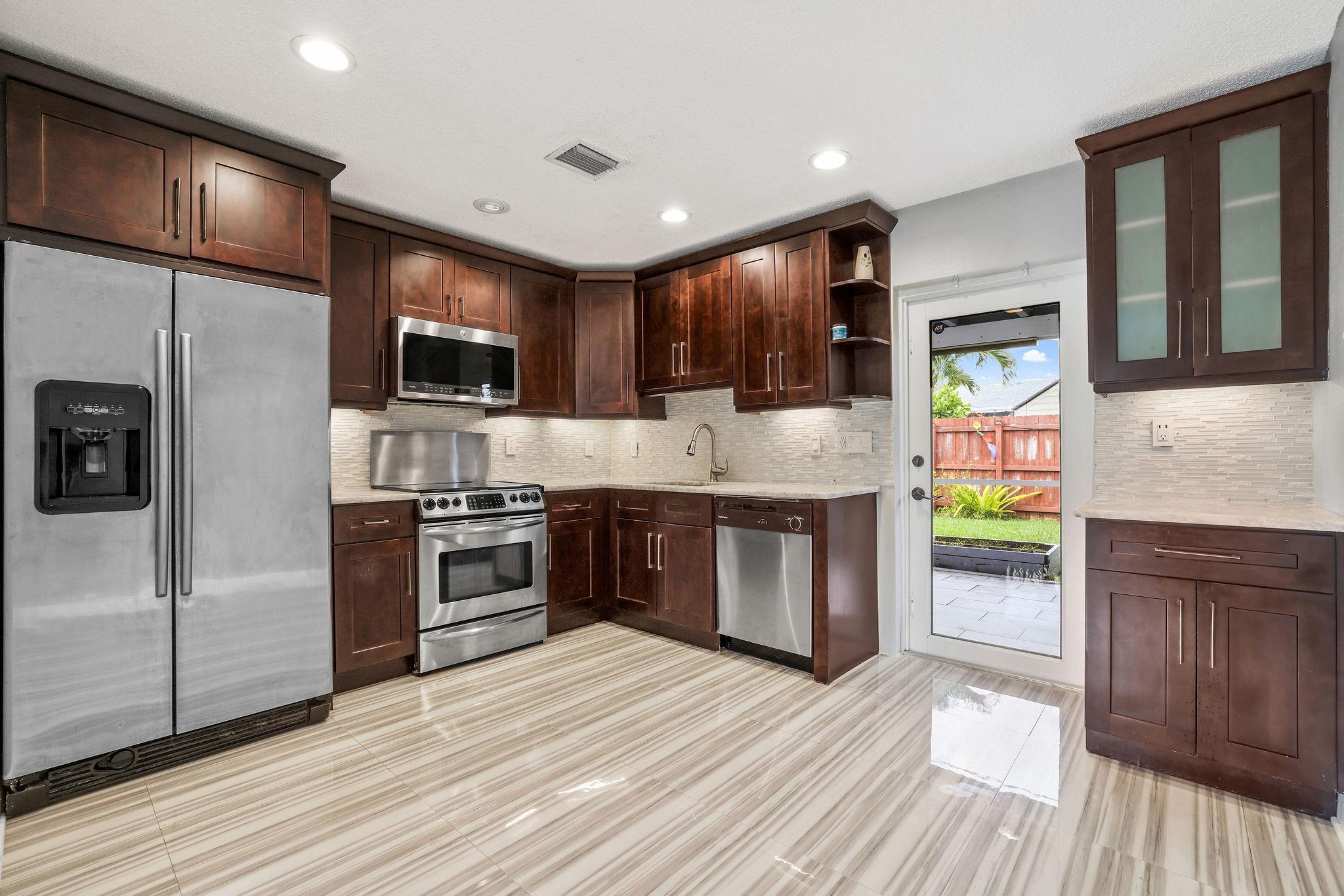 This substantially remodeled 2-bedroom, 1-bath single-family home in Tamarac Lakes South is move-in ready and loaded with upgrades. It features a modern kitchen with new appliances and upgraded cabinets, a sleek renovated bathroom, and tile flooring throughout for easy maintenance. You'll also find all-new hurricane-impact windows and doors offering style and storm protection. Fresh interior paint and abundant natural light make the living spaces feel like new. Enjoy the convenience of an in-home washer and dryer, and step outside to a private, fully fenced backyard—perfect for morning coffee or weekend gatherings. This delightful home blends modern safety features with classic Florida charm. The community offers a clubhouse and heated pool, completing the ideal South Florida lifestyle.