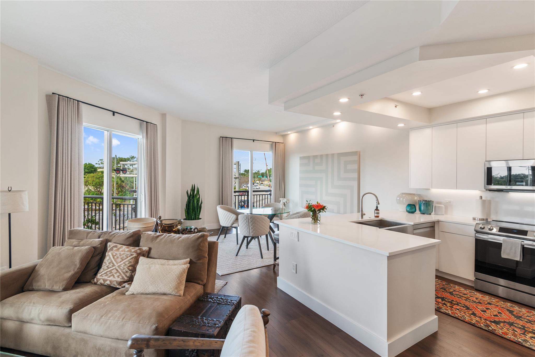 This stunningly designed & completely remodeled 1 bedroom 1 1/2 bath unit is located at Wilton Station, a premiere luxury condominium located in Wilton Manors. Kitchen boasts modern white cabinets, white quartz countertops, & a brand new Sub Zero Pro Series refrigerator. Waterproof hybrid resilient flooring throughout, newly painted with Benjamin Moore, new custom wool drapes from Shade Store, new 3-ton Rheem HVAC, Samsung W/D, new Brizo shower system, new Hansgrohe faucet in main bathroom, Nest thermostat, ADT key pad & touchpad front door lock. Large balcony with multiple sliders & storage room. Amenities include a swimming pool 2 spas & a waterfall, 2-story state of the art gym, 24/7 security & booth at entry, dock for kayaks, movie theater, party room with bar, & EV charging station.