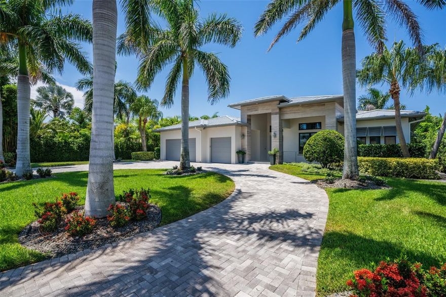 Chance-of-a-lifetime to own this luxury waterfront estate on Coronado Island in the prestigious Venezia boating community of New Smyrna Beach, minutes from the beach. Built in 2018, this meticulously maintained 4BR/3.5BA custom home features premium concrete block construction, elevated flood rating, impact windows/doors, Italian limestone exterior accents, and exquisite designer finishes throughout. Highlights include a chef’s kitchen with waterfall quartz island, KitchenAid appliances, induction cooktop, wet bar, and wine fridge; a spa-like primary suite; Tesla charger; smart-home controls; whole-house generator; and heated saltwater pool. Boater’s dream with 20,000-lb and 8,000-lb covered lifts, floating dock, fish tackle room, and summer kitchen. Extensive recent upgrades.