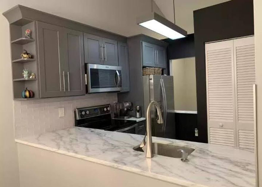 Beautifully renovated 1BR/1BA condo on the second floor offering great privacy. Features include wood flooring, granite countertops, updated kitchen with stainless steel appliances, vaulted ceilings, and a private balcony. Located in a gated community with resort-style amenities including a pool, fitness center, and tennis courts. Conveniently close to shopping, beaches, and I-95.