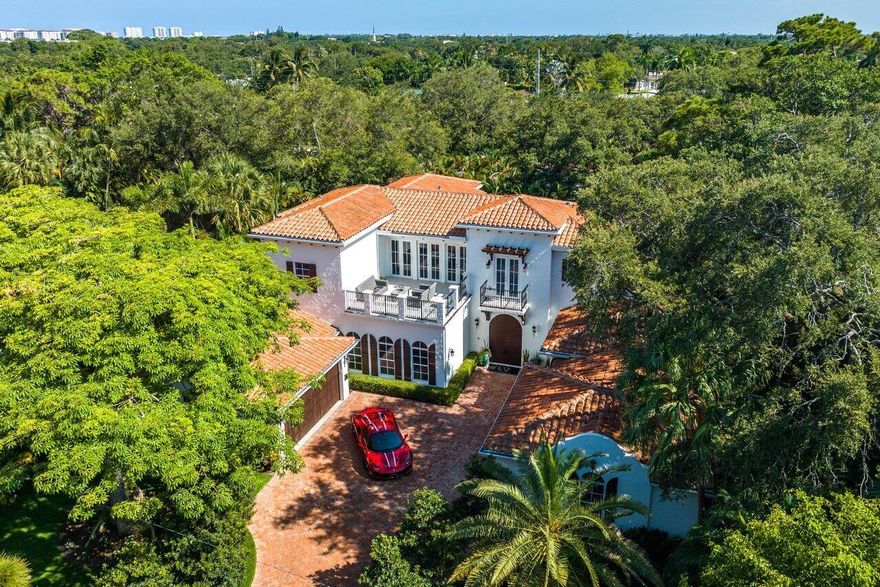 Nestled in the historic neighborhood of Old Floresta, this 2017 constructed Spanish-Colonial inspired estate boasts stunning architectural design surrounded by beautiful Pink Silk Floss trees and well-kept gardens. With 6 bedrooms and over 7,000 square feet under roof, this palatial residence offers complete privacy on sprawling grounds adorned with mature areca palms. The spacious living areas feature Italian porcelain flooring, chic chandeliers, crown molding, and volume ceilings. The high impact windows and doors allow natural light to flood the home. The gourmet kitchen features stainless steel Wolf appliances, an 11-foot island, and an airy breakfast room overlooking the lanai. The luxurious master suite, situated on the first floor for added privacy, features duel water closets...