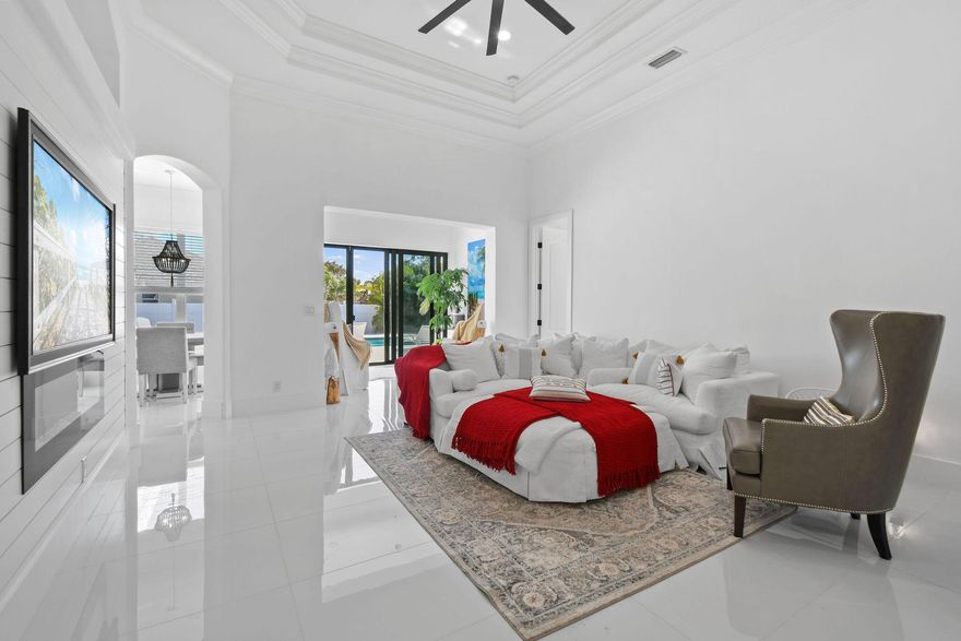 Every inch of this beautifully updated 4 BR / 2 BA/ 3,085-LSF home perfectly blends elegance, comfort & functionality. Each detail feels intentional - from the luxurious primary retreat to the open-concept kitchen that flows effortlessly into the family and dining areas. The home's cohesive design continues outdoors with 2172 SF of sparkling resort-style pool, travertine paver decking, and a tiki retreat - creating a harmonious extension of living space ideal for entertaining & relaxation. This versatile floor plan also includes formal living & dining rooms, den, and Florida room spacious, inviting, and designed for everyday living. Other features include Calacatta-style quartz waterfall island, coffered ceilings, crown molding, sleek porcelain tile throughout, and so much more!