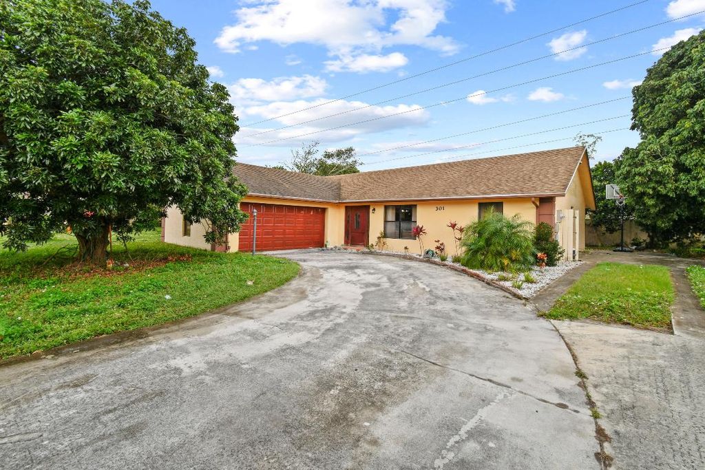 Photo of 301 Canterbury Drive W, Riviera Beach, FL 33407 (MLS # R10947680)