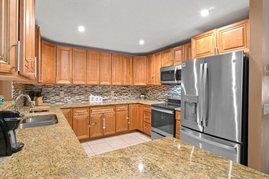 Photo of 301 Canterbury Drive W, Riviera Beach, FL 33407 (MLS # R10947680)