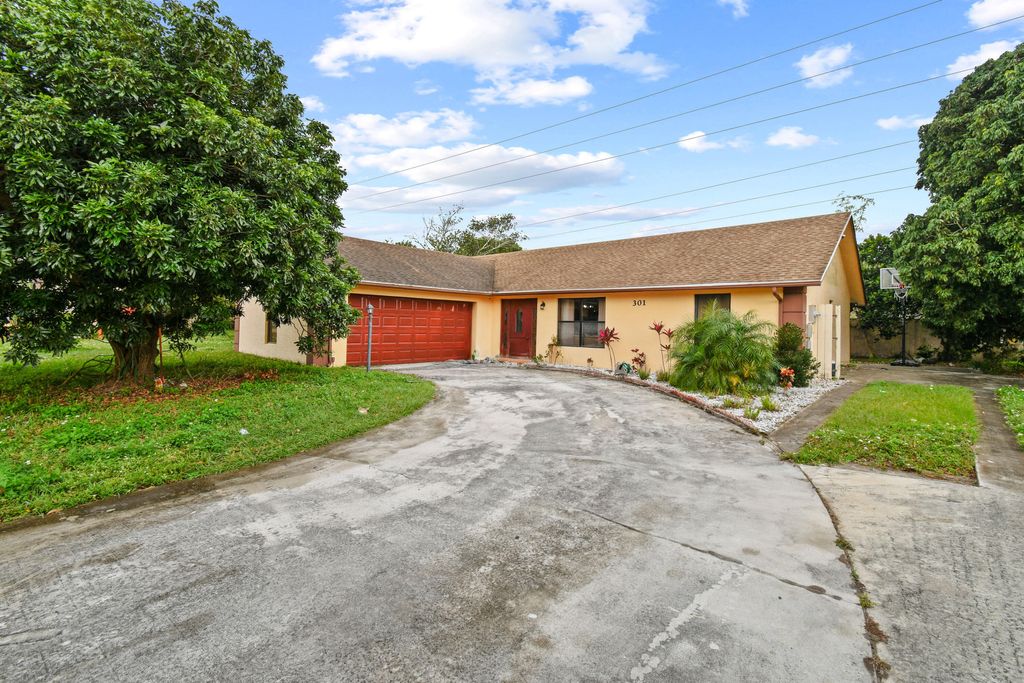 Photo of 301 Canterbury Drive W, Riviera Beach, FL 33407 (MLS # R10947680)