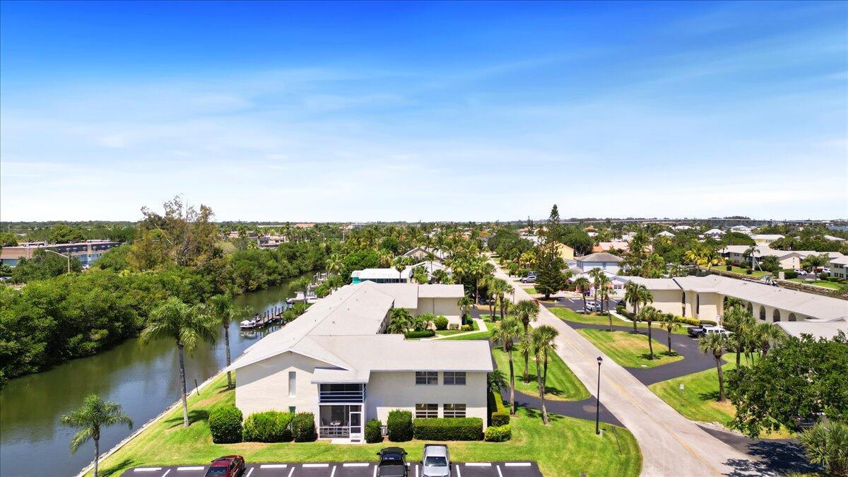 Oh, give me a place where the manatees race! Modern, open condo w/boat dock access on canal to Intracoastal Waterway! Scr porch looks out to canal & dock! Close to Miracle Mile shopping & restaurants. Near proposed Three Corners waterfront site; only 2.5 mi to the beach! New Roof June 2025! Updated kitchen & baths w/comfort-height vanities. Diagonal tile & textured ceilings. Recessed lighting. Master suite w/walk-in closet.Tankless HW heater. Up to 25' boat allowed. Community of 100 units nestled among single family canal homes. Perfect place to invest, downsize or enjoy the winter!