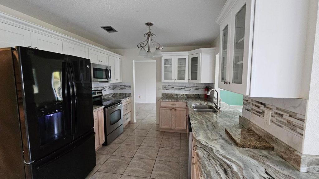 Photo of 3002 SE Dalhart Road, Port Saint Lucie, FL 34952 (MLS # R11157655)