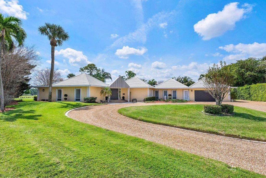 Photo of 261 N Country Club Drive, Atlantis, FL 33462 (MLS # R10970299)