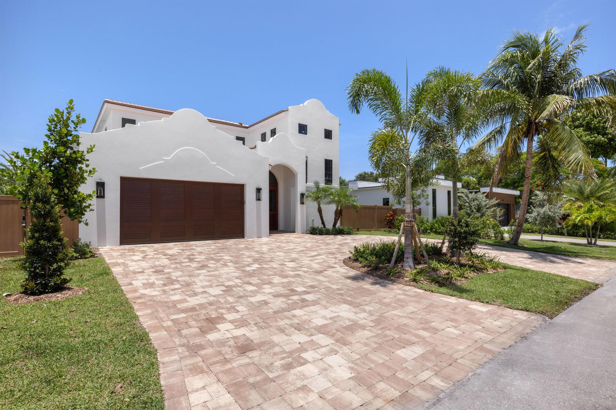 Welcome to 309 Cascade Lane the only brand-new construction home in all of Palm Beach Shores. This stunning Spanish Colonial-style residence is truly one of a kind, offering a luxurious blend of elegance and comfort. Situated on a prime lot, the home features a governor's driveway and a spacious two-car garage with durable epoxy floors--complete with a brand-new 6-seater golf cart to enjoy the golf-cart-friendly community of Singer Island.