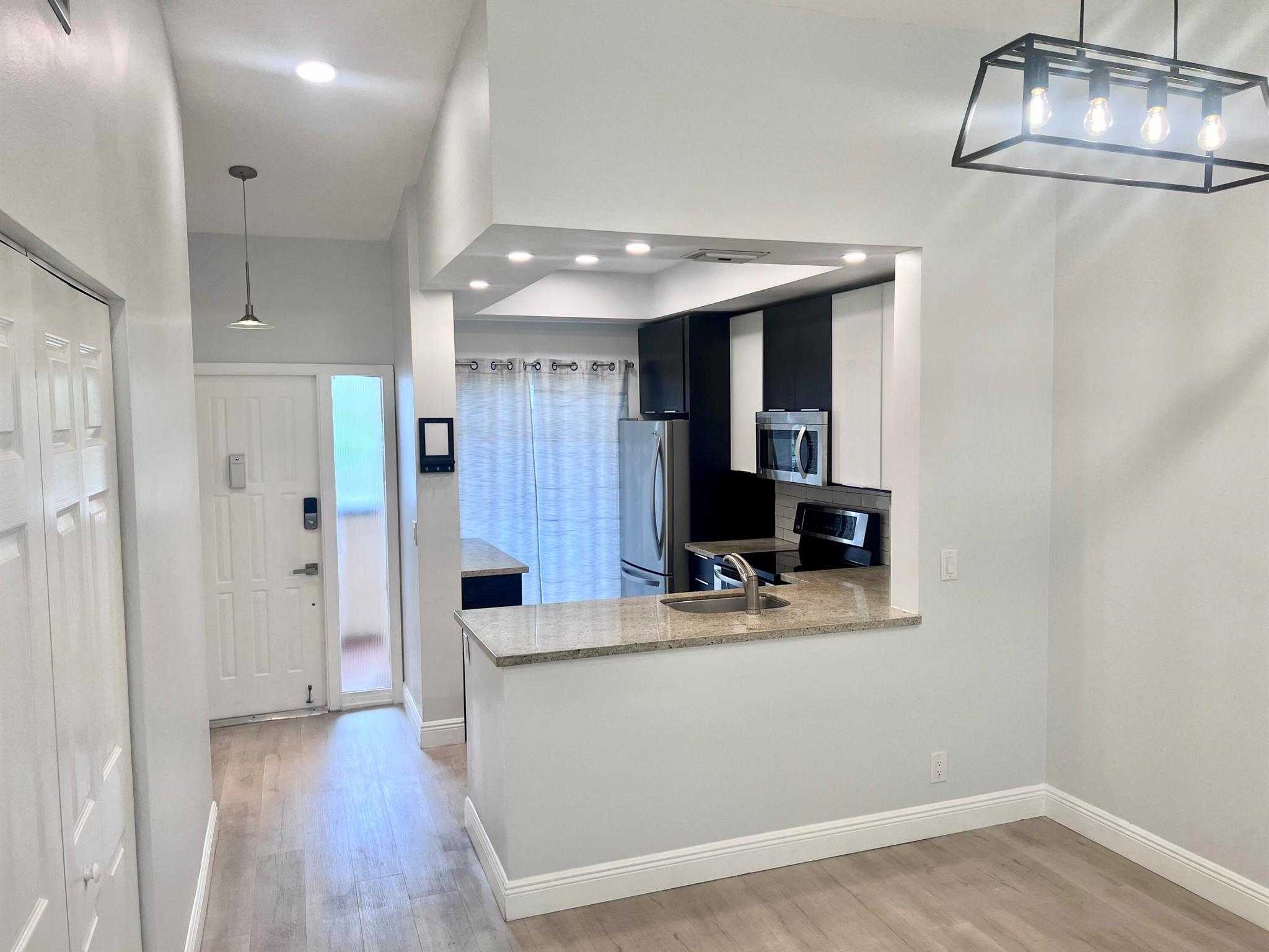 Beautiful 2/2 second floor renovated condo with vaulted ceilings and recessed lighting through out. Full size Washer & Dryer inside unit, a large enclosed patio. Close access to I-95, Turnpike, and the Sawgrass Expressway in the Meadowridge neighborhood of Deerfield Beach. Well maintained community and safe area. 10 minute drive to the beach. 2 spacious bedrooms (1 with walk-in closet). 2 full baths. Renovated modern kitchen, bathrooms and floors throughout. Updated stainless steel appliances. 1 designated parking space with plenty of guest parking spaces available. NO PETS, NO WORK VEHICLES, NO MOTORCYCLES, per HOA. NO SMOKING. (allow 30 days for approval). 1 year (renewable) lease. Includes: Water, Sewer, Basic cable, well maintained grounds with lake, pool and and clubhouse with gym.