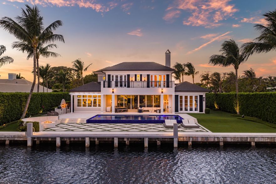 Beautifully appointed and thoughtfully rebuilt in 2017, this transitional waterfront residence is ideally situated within the coveted enclave of Au Soleil in Gulf Stream. Offering 105 feet of deepwater frontage along the Intracoastal Waterway, the property is perfectly suited for the boating enthusiast, blending refined design with effortless coastal living. The home's open-concept main living level is designed for both elevated entertaining and everyday comfort, featuring a chef's kitchen with dual oversized islands, premium Thermador appliances, and a sunlit breakfast nook. The expansive living area flows seamlessly to a resort-style pool and outdoor spaces, all framed by sweeping Intracoastal views.  Additional highlights include a whole home generator and fully integrated Crestron system with Vantage lighting system, a sophisticated wet bar, a beautifully curated wine room, and a private den or office just off the main living area. A first-floor primary suite offers a serene retreat, complete with a spacious custom-built closet, a luxurious bath, and a private outdoor shower. The residence encompasses four bedrooms, four full and one half bathrooms, a two-car garage, and an upstairs flex space adaptable to a variety of lifestyle needs. This exceptional waterfront offering combines timeless transitional style, modern construction, and an unbeatable Gulf Stream location.