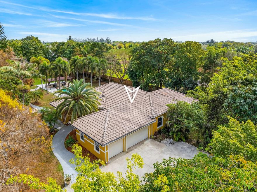 Experience modern comfort and rural tranquility on this 1.18-acre estate. This 3-bed, 3-bath residence with a 3-car garage offers 2,374 sq. ft. of light-filled space, high ceilings, and a chef’s kitchen with stainless appliances. A standout feature is the detached independent building, ideal as a guest house or private office. The primary suite is a true sanctuary, boasting 'his and hers' vanities, a Jacuzzi, and dual shower entries. Enjoy direct access to the private pool and a serene, covered lounge area. Perfectly located near major highways and city conveniences, this property offers a privileged lifestyle with plenty of room to grow. Your equestrian-friendly paradise awaits in Southwest Ranches. Additional 4th Bathroom in Detached Structure.