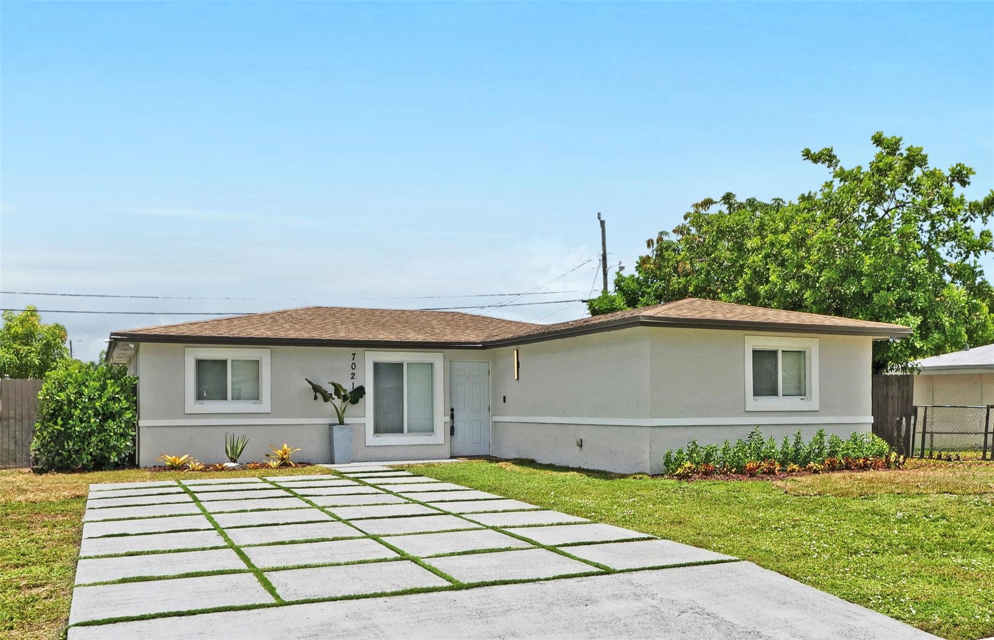 This beautiful 3 bedroom, 2 bathroom home boast a 6 car driveway with a huge fenced backyard that wraps around giving access points on both sides allowing for additional storage and parking. Bring your company vehicles, boats and RV's! Its private and there are no parking restrictions! This home is also equipped with high impact windows and doors, wired camera system, tankless water heater, stainless steel appliances, wooden cabinets in the bathrooms and kitchen which is complimented by granite countertops and the ceramic tile floors flow seamlessly throughout the open floor plan. There's lots of storage spaces and a designated laundry room with additional storage. Conveniently located near schools, shopping centers, and all major highways. Come see all the features this home has to offer!