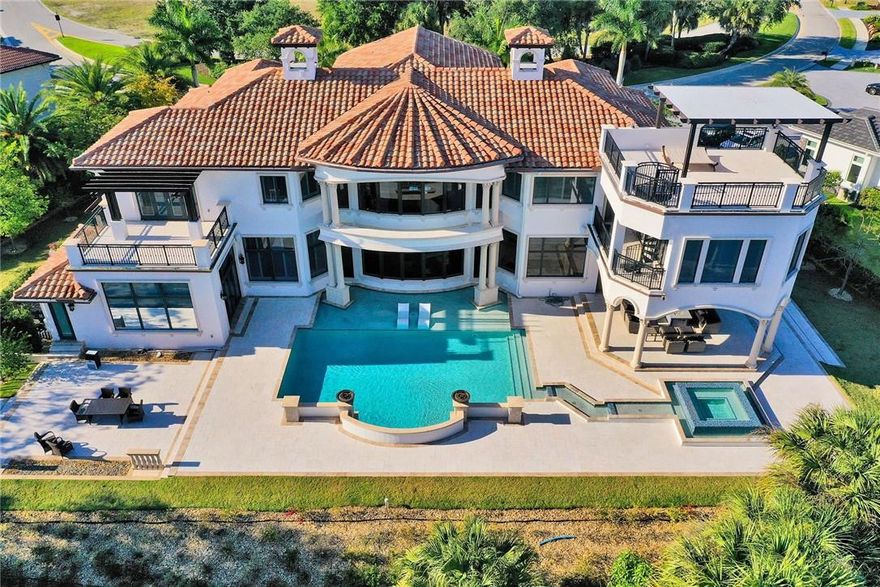 Built in 2017, this nearly 9000 sqft custom estate sits on one of the most desirable streets in Parkland. Dual entry gates lead you onto your private driveway, where you are greeted by this masterpiece. Steps lead you up to your double door entry where a floor to ceiling, glass wine wall welcomes you as you enter your new home's foyer. Head upstairs to the master retreat & enjoy views like no other, using a private staircase to the roof-top observatory. See expansive views of PGCC’s private golf course, your resort-style pool w/cabana & kitchen 3-floors below you. This home has many notable features, including 30’ ceilings, open-style kitchen, theater, office, gym, 4car garage, but seeing it in person is the only way to really experience all it has to offer! It will take your breath away! Matter port tour available for an in-depth look.