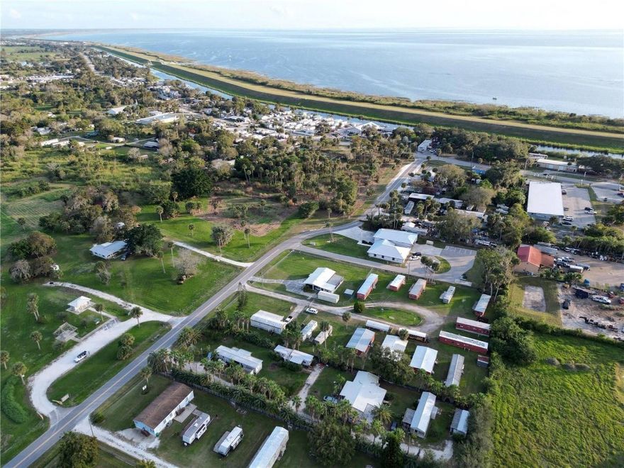 Attention Investors! Great Income Producer! 5 unit Mobile home park, Nicely landscaped on an .81 acre lot, only a mile away from Lake Okeechobee! Electric is individually metered, 4 septic tanks onsite, city water, one water meter, Low expenses, fenced, central ac/heat, newer metal roofs, approx 4 years old. All mobile homes are park owned! #1 three bedroom 2 bath doublewide, #3 Two bedroom 1 baths singlewides, and an RV. (Also available is a 3 unit mobile home rental property with a nursery on site, if a package sale is desired for more income production. That property is two parcels north) SELLER FINANCING AVAILABLE! CALL TODAY FOR A SHOWING!