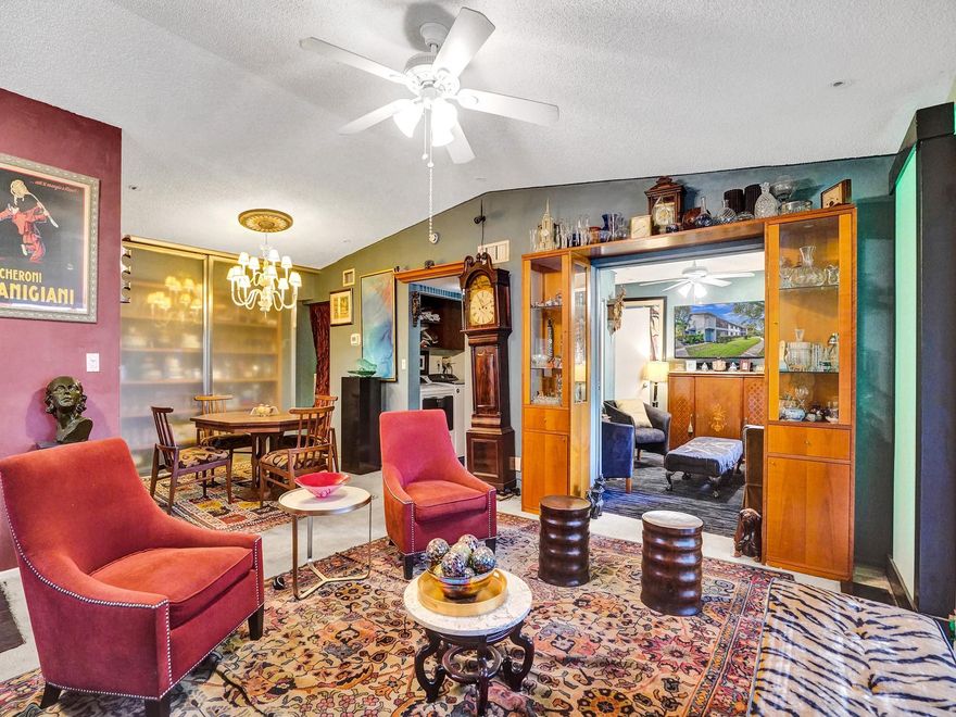 2nd floor corner unit with private entrance, vaulted ceilings, screened porch with beautiful view, carpet and tile floors, kitchen with passthrough to dining area, 2nd bedroom opened up to living room with pocket doors for additional light. Can be used as family room or 2nd bedroom. According shutters on all windows and slider. Full size washer and dryer - newer 2021, large pantry in dining area, large master bedroom with walk in closet with attic access storage, in-line hot water heater, large fountains in the complex and beautiful community pool area. Easy access to I-95 (located just west), close to downtown Wilton Manors and the beach which is directly east on Oakland Park Blvd. Chandelier can stay or go.