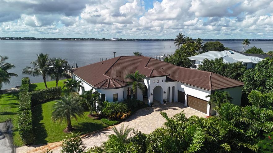 FIRST TIME ON MARKET! Premier waterfront location built in 2020. Modern-Mediterranean home close to downtown Jensen Beach and Stuart. Spectacular southern exposure and wide-water view. Direct ocean access minutes from the St. Lucie Inlet. No low bridges - a boater's dream. High coffered ceilings, four spacious bedrooms plus a den, four full baths, and a cabana bath designed for everyday comfort and effortless entertaining. Gourmet chef's kitchen, top notch appliances, quartzite counters, custom cabinetry, walk-in pantry. Private waterfront with covered dock, two high-speed boat lifts, personal watercraft lift, and lowered platform for kayaks and paddle boards. Room for your yacht or sport-fish. Heated saltwater pool, spa tub, sun shelf, and iridescent glass tile.