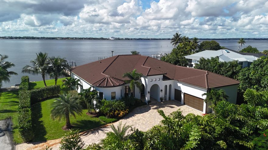 FIRST TIME ON MARKET! Premier waterfront location built in 2020. Modern-Mediterranean home close to downtown Jensen Beach and Stuart. Spectacular southern exposure and wide-water view. Direct ocean access minutes from the St. Lucie Inlet. No low bridges - a boater's dream. High coffered ceilings, four spacious bedrooms plus a den, four full baths, and a cabana bath designed for everyday comfort and effortless entertaining. Gourmet chef's kitchen, top notch appliances, quartzite counters, custom cabinetry, walk-in pantry. Private waterfront with covered dock, two high-speed boat lifts, personal watercraft lift, and lowered platform for kayaks and paddle boards. Room for your yacht or sport-fish. Heated saltwater pool, spa tub, sun shelf, and iridescent glass tile. 3-car garage, impact windows & sliders, huge covered patio, backup generator, 1,000 lb in-ground propane tank. Perfect balance of comfort, convenience, and breathtaking waterfront views. Don't miss your chance to own it!