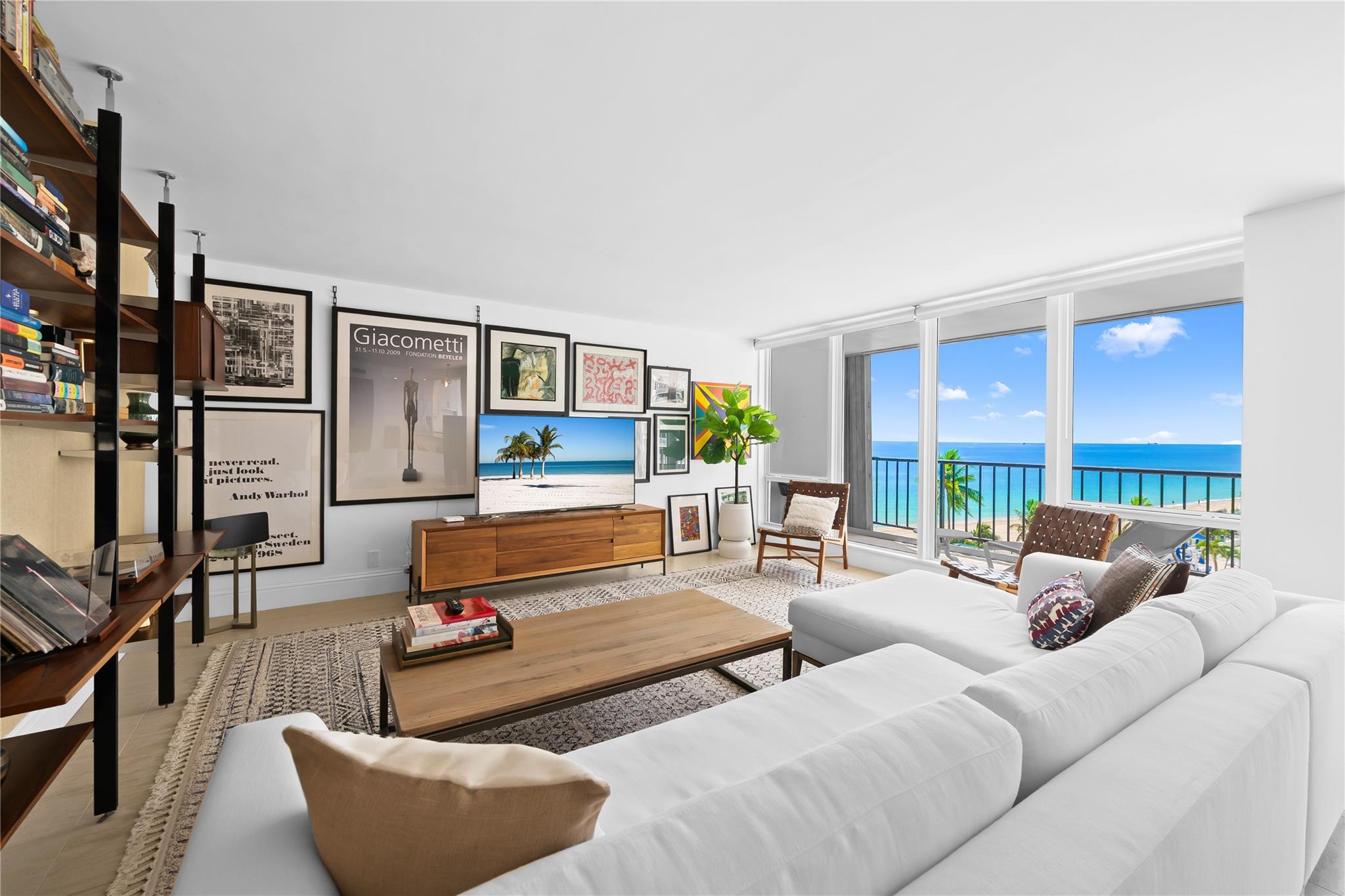 Arrive at your stunning, fully renovated beachfront condominium via semi-private elevator & foyer. Enjoy breathtaking direct ocean views as soon as you enter. Brand new floor to ceiling impact windows and doors with custom electric shades throughout. Open concept with bright white kitchen , stainless steel appliances, butcher block–style countertops, breakfast area, plus a laundry room. Both bathrooms are fully remodeled—the primary with floating vanity, double sinks, oversized shower w/ multiple attachments, and a custom walk-in closet. Imported 24 inch porcelain tiles throughout. Large balcony overlooks the pool and ocean. This flow-through unit feels like a home, with resort-style amenities: Saltwater infinity pool, private beach access, grilling deck, sauna, gym, 24hr security & more.