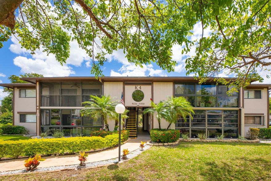 Completely Remodeled First Floor Condo Located In Kings Point In Tamarac! Beautiful 2 Bedroom 1 Full Bath with no stairs!  Main bedroom is oversized for a king size bed and offers a  HUGE walk in closet in lieu of the 2nd full bathroom. 2022 laminate flooring , paint , A/C, fridge, washer & dryer. Bathroom  has stylish tile work, shaker cabinets & quartz tops. The 42" upper kitchen cabinets are perfect for the chef. Living room is large & open to the kitchen & dining for all your entertaining. Enjoy a game of cards,bunco or mahjong in your sunroom overlooking the peaceful, mature landscape. Kings Point Clubhouse has over 50 groups for you to be a part of, theatre, tennis, pickleball, pools, fitness and so much more! Hop on the community bus for all your fun! Resort Style Living! Must See!