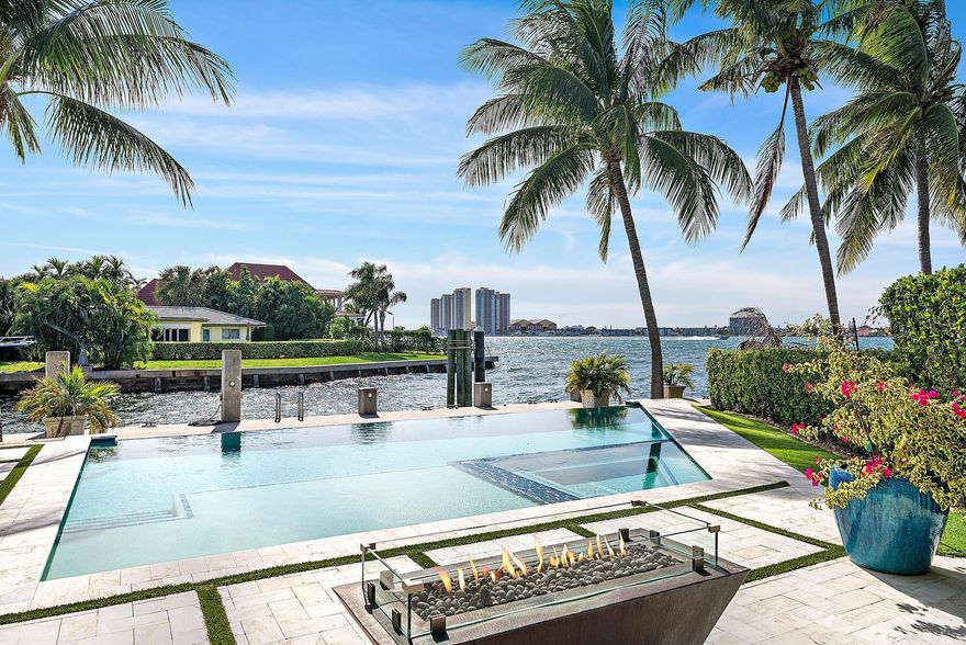 First time on the market, the view truly says it all.  This exceptional waterfront home was thoughtfully designed to maximize views of the intracoastal. Offering 4217 sf of light-filled living space (6014 total SF), this sophisticated residence blends elegance, comfort, and the very best of South Florida waterfront living. A private elevator leads to the upstairs primary suite, a serene retreat showcasing spectacular water vistas. Two additional guest suites up and a fourth on the main level provides ideal flexibility. With an impressive 153' of waterfront and a 2014 concrete dock and seawall w/batter piles, this property is perfectly equipped for the serious boater- 5 min to inlet. Features include a 90' dock w/ power & water, a 28,000 lb hi-speed Neptune lift to fit 50' boat.