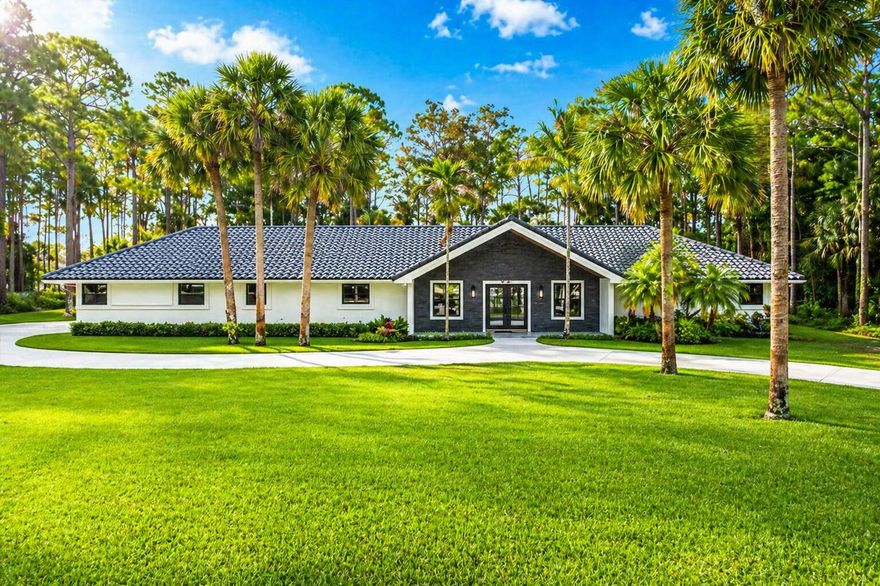 Experience exquisite luxury living on 2.1 acres in the tranquil neighborhood of Paddock Park, ideally located in the heart of Wellington renowned for its world-class equestrian lifestyle, all A-rated schools and vibrant community events. This beautifully redesigned masterpiece offers the perfect blend of sophistication and comfort featuring top-of-the-line total interior renovations, newer exterior improvements, all set on an expansive private lot you will love to call home. This residence showcases 5 spacious bedrooms, 4.5 bathrooms, and a truly exceptional backyard designed for entertaining and everyday relaxation. Inside, a bright and open floor plan is enhanced by high-end finishes and thoughtful designer touches throughout. At the heart of the home is a stunning gourmet kitchen complete with state-of-the-art Thermador appliances, custom cabinetry, modern quartz countertops, and an oversized island perfect for gathering. The lavish primary suite serves as a private retreat, featuring a spacious walk-in closet, a spa-inspired bathroom with dual floating vanities and large glass shower. This home features newer and impeccably maintained mechanical systems and household appliances, including A/C units (2021-2024), water heater (2021), impact glass windows and doors providing peace of mind for its new owner. Step outside to your own resort-style backyard oasis complete with pool, deck and fire pit designed for lounging, family fun and entertaining. The outdoor kitchen includes a built-in BLAZE grill, bar seating, and plenty of space to host BBQs, birthday parties, game days and holidays year round in the perfect South Florida weather. Surrounded by lush greenery and mature trees, this estate offers a serene, park-like setting with room for gardens, recreation, building additions and endless possibilities. Enjoy plenty of space and privacy with room for RV and boat parking plus the versatility to add onto or customize the property all within a subdivision that has no HOA fees or restrictions in one of Wellington's BEST communities!  Living in Wellington offers a lifestyle that blends elegance, space, and year-round outdoor living in one of South Florida's most desirable areas. Known as the Winter Equestrian Capital of the World and home to the renowned Winter Equestrian Festival, Wellington delivers a unique energy while still maintaining a peaceful, family-friendly atmosphere with top-rated schools including the highly anticipated Wingrove Academy slated to open in August 2028 developed by ElevateED and backed by Related Ross, the 45-acre campus will feature a strong focus on STEAM, sustainability and athletics near scenic trails, and beautifully maintained parks. Wellington is ideally situated just outside of West Palm Beach, one of South Florida's fastest-growing hubs, residents enjoy effortless access to a lively dining, shopping, and entertainment scene. Spend evenings along Clematis Street or at Rosemary Square, and explore premier cultural venues like the Norton Museum of Art, Henry Morrison Flagler Museum, and the Kravis Center for the Performing Arts. For golf enthusiasts, the area offers an impressive selection of highly regarded courses including Wellington National Golf Club, The Wanderers Club, PGA National, Bear Lakes, Breakers West, Trump International and Lost City at Atlantis delivering premier playing options. Beyond golf, residents also enjoy being a short drive away from pristine beaches and a variety of attractions including the Palm Beach Zoo, Cox Science Center and Aquarium, Mounts Botanical Garden, and Okeeheelee Nature Center. With convenient access to I-95 and the FL Turnpike, commuting and travel are effortless, connecting you to nearby cities like Palm Beach Gardens, Delray Beach, Boca Raton, and Fort Lauderdale. Residents are also just minutes from Palm Beach International Airport, have access to Fort Lauderdale-Hollywood International Airport, and can take advantage of the new Brightline high-speed train providing service between Miami and Orlando. This prime location delivers a lifestyle that is both peaceful and connected, schedule your private showing today to experience it firsthand.