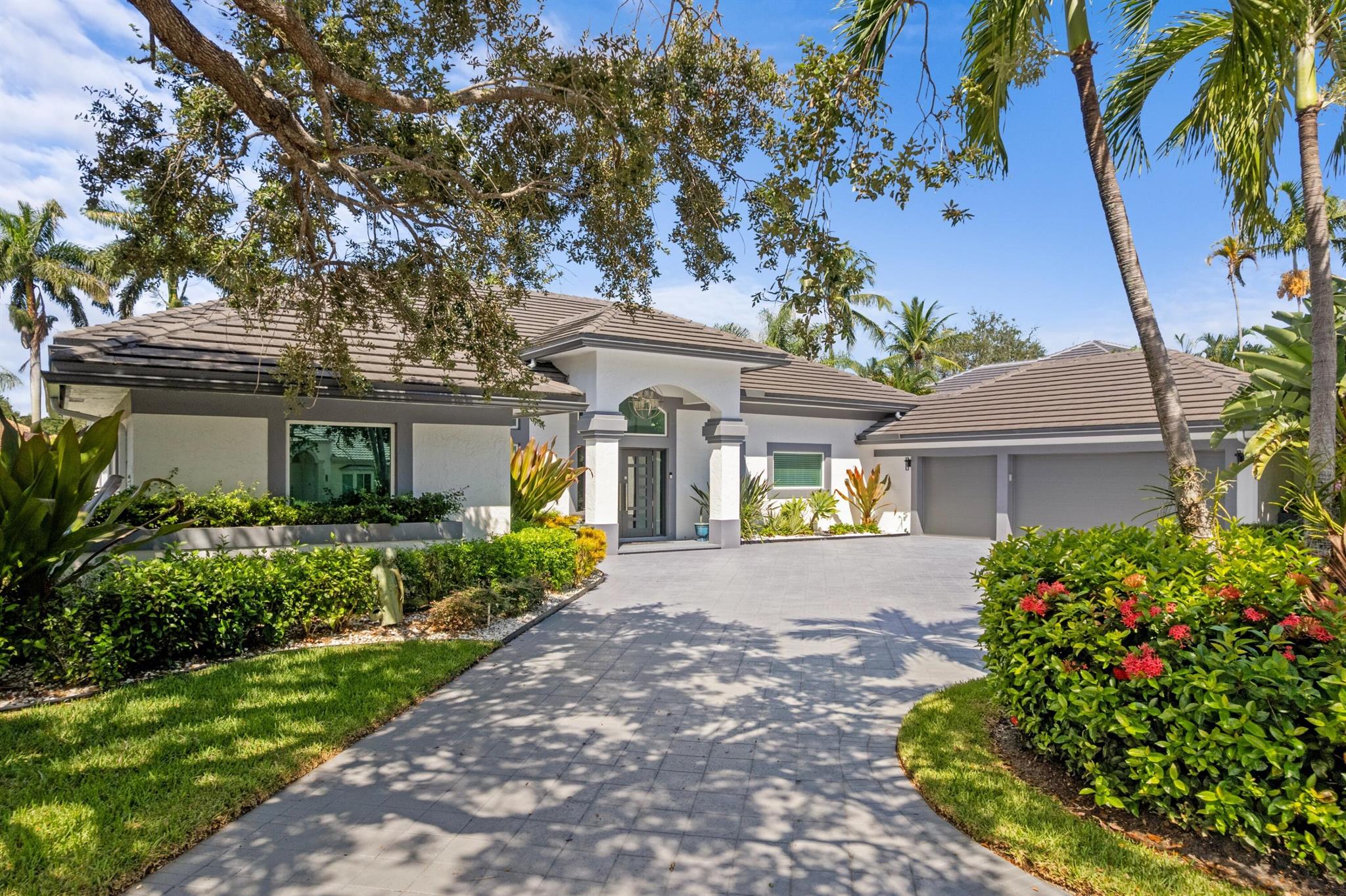 This exquisitely renovated, turn-key residence in Bear Lakes Estates sits on a lushly landscaped half-acre lot in one of West Palm Beach's most prestigious gated golf communities. Spanning 4,500 sq ft on one level, the home features 6 bedrooms, 4.5 bathrooms, and a 3-car garage with a thoughtfully designed split floor plan. A private wing provides the ideal space for children's rooms, a play area, or an in-law/nanny suite. Every detail has been upgraded, including all new impact windows and doors, three brand-new AC units, roof, kitchen & bathrooms, automated window shades & more. Soaring ceilings with transom windows bathe the interior in natural light, while the 15x40 heated saltwater pool, expansive patio, summer kitchen, & spacious yard create the perfect setting for outdoor living.