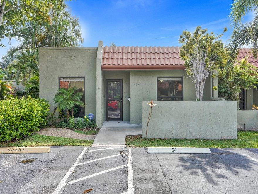 Beautiful villa ready and waiting for you to move right in.  This all age corner villa has a great east location with lots of square footage and enclosed patio with impact windows for even more room.  Open the triple slider and walk out the enclosed patio to the heated pool and club room. Eat in updated kitchen with new stainless steel applicances.  Washer and dryer in unit.  Roof was competed in 2019 and AC 2022.  This unit has electic blinds and is partially furnished in neutral colors, included in purchase.  Corner unit with parking at the front door and many guest spaces.  Close to award winning Deerfield Beach, shopping and restaurants.