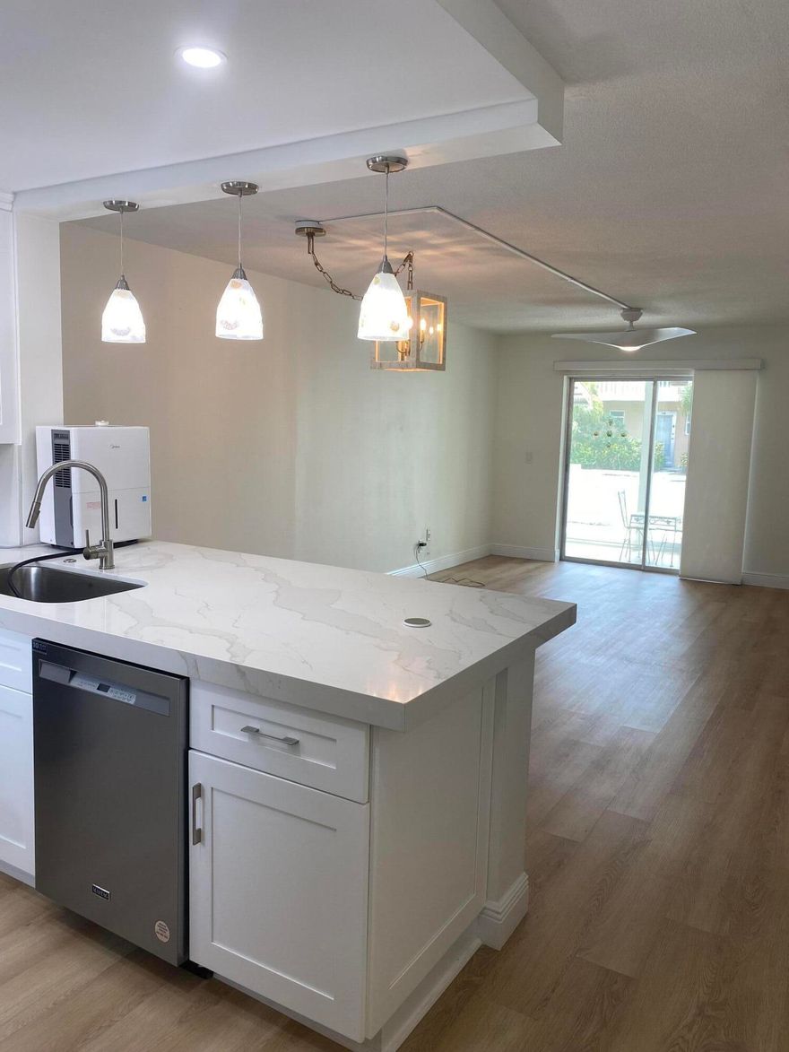 Fully renovated gorgeous white condominium East of I-95 and minutes to the beach makes this home a great value!  Minutes to the Ocean and convenient to everything!  2 Bedrooms and 2 Bath Corner Unit on the first level near the Pool so convenience and relaxation awaits you!   Washer and Dryer in the unit. Parking spot directly in front. No work to do so just move in!  Call for appointment and seller is ready to entertain an offer!