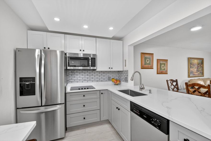 Ground floor, Parking right in front of your door, Updated with a beautiful patio w garden view and private. Completely updated! bedroom + DEN  and 1.5 bathroom, with This home offers a bright and open floor plan with beautiful and serene garden views and a BBQ Area. Beautiful brand new kitchen featuring shaker cabinets, sleek quartz countertops with extra space for barstools area, new SS appliances and LED lights. New neutral porcelain wood-looking tile throughout the whole unit. Remodeled bathrooms, Fresh Paint. Concrete roof, New barn doors dividing Living room from the the lFlorida/Porch area. fantastic 55+ community with two clubhouses, two pools , Spa, Theater, Gym, Tennis/Pickeball courts, HOA includes Cable, Water, Building insurance, Pest control,