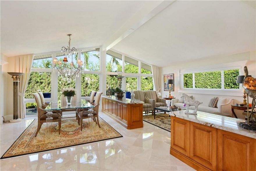Offering a supreme location & refined elegance this renovated home is positioned on a quiet corner in the heart of Coral Ridge CC. The gated 3BR+Den/2BA/2CG pool home boasts an open floor plan, vaulted ceiling‘s, floor to ceiling impact glass, marble flooring throughout, custom cabinetry, millwork & finishes. The views are enhanced by beautifully designed water features, custom lighting and exquisite landscape that surround the property. Steps to Bayview Park, restaurants, beach. Perfect for entertaining!