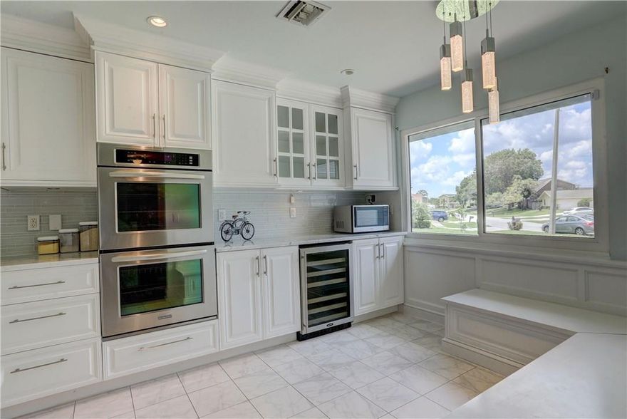 Welcome to this beautifully remodeled home! Chef's dream kitchen features double ovens, custom cabinets, glass tile backsplash and marble counter tops. All bathrooms have been updated with designer finishes. New flooring throughout the whole home. A/C 2016. Roof 2008. New washer and dryer. Impact windows and storm shutters. Large lot features room for boat or R/V parking, mature mango tree, room for a pool. Garage is converted to additional living space but can easily be converted back.