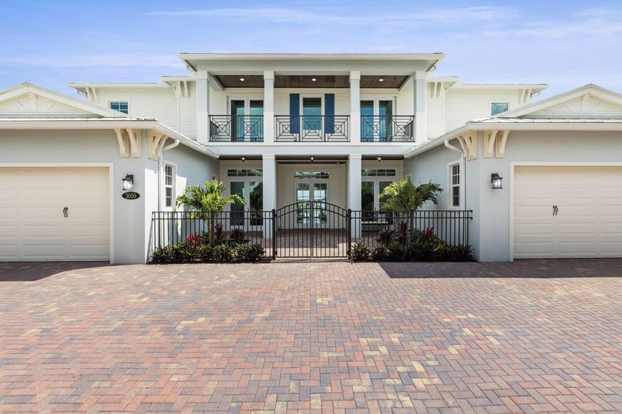 Welcome to a unique opportunity to own waterfront luxury living at its finest. This meticulously designed coastal-style estate is a boater's dream, boasting nearly 6000 square feet of living space with 5 bedrooms, 6.5 baths, and four garage spaces. From the moment you step inside, you'll be greeted by an incredible 30-foot foyer featuring a double curved staircase, setting the tone for the entire home. This estate features custom built-ins, a chef's kitchen with gourmet Sub Zero/Wolf appliances and a large kitchen island, a club room for entertaining with a full kitchen, formal dining and living rooms, and a double-height great room.