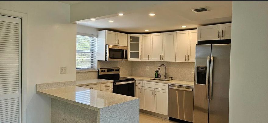 Location, Location, Location! Beautiful and fully remodeled 2-bedroom, 2 bathroom with an enclosed balcony and lake view, polished porcelain tiles, his & hers walk-in closets, hurricane impact windows and doors, gorgeous bathrooms, custom kitchen cabinets with granite countertops, stainless steel appliances, spacious 1,203 SF, washer and dryer, and brand-new master bathroom. It won't last!