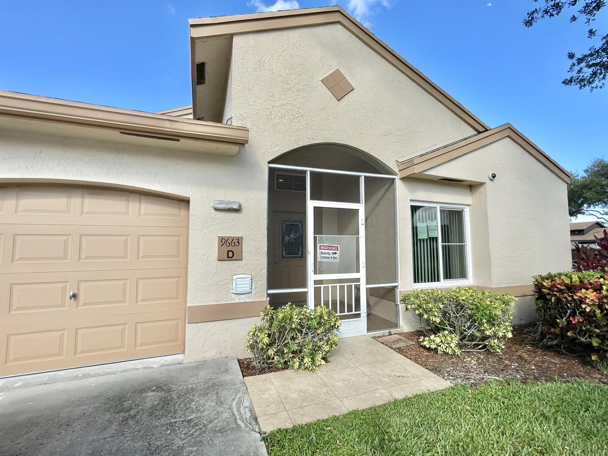 Beautiful 4 Bed 2 Bath, total under A/C 1587 sqft +357 sqft (converted bedrm/sun room from patio). 1 sink in converted patio to room under a/c. ALL windows+doors hurricane proof. Everything top of the line - custom white cherry wood kitchen cabinets - 3 rows from ceiling to floor. Oversize washer +dryer machines in kitchen area, closed in w/ sliding doors. appliances, 17 gears, 2 motors, 4 ton A/C, Custom made closets, front walls w/ beautiful 14 ft trees, ADT system + 5 outside cameras includ. Garage also under A/C with 17 Kitchen Cabinets, 2 parking spaces + Garage. Boca Gardens offers Olympic sized pool w/ 180 view of oversized lake, fitness center, basketball, tennis courts, tot lot, and handball. 24/7 security patrol. Pets okay.